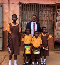 Wisdom Dordoe, founder of Give Me Hope Foundation and some of the school children