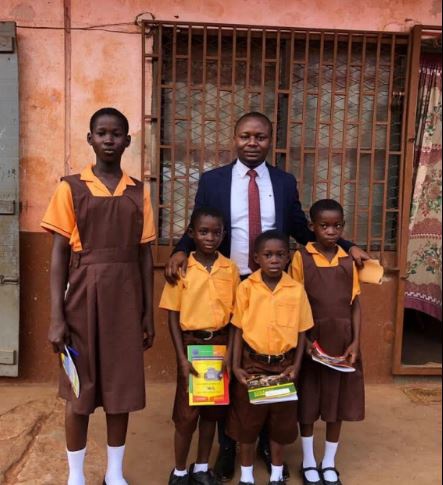 Wisdom Dordoe, founder of Give Me Hope Foundation and some of the school children