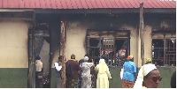 Staff and some of the members of the school's take a look inside the burnt dormitory