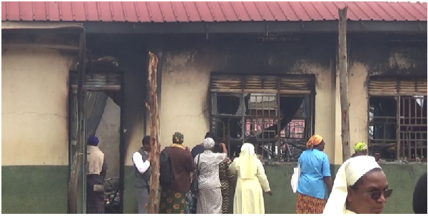 Staff and some of the members of the school's take a look inside the burnt dormitory