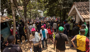 Burundian nationals gather outside their embassy to apply for border passes