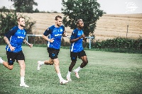 Patrick Twumasi with some team members at the training ground