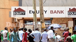 People line up to withdraw money at an Equity Bank ATM at Kabalagala along Ggaba road in Kampala