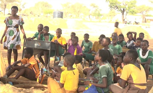 Some students from Amenga-Etego Primary School in their 'classroom'