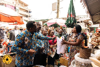 Dr Johnson Asiama pictured with a trader at the Makola Market