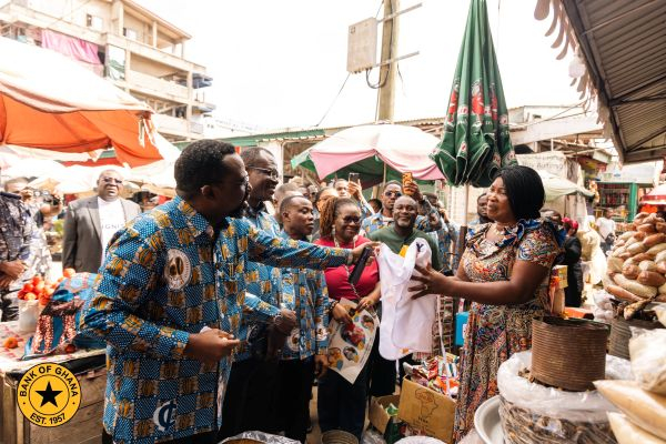 Dr Johnson Asiama pictured with a trader at the Makola Market