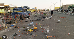 A security person patrols at the scene of Monday's bomb blast at a market in Maiduguri, March 17, 20