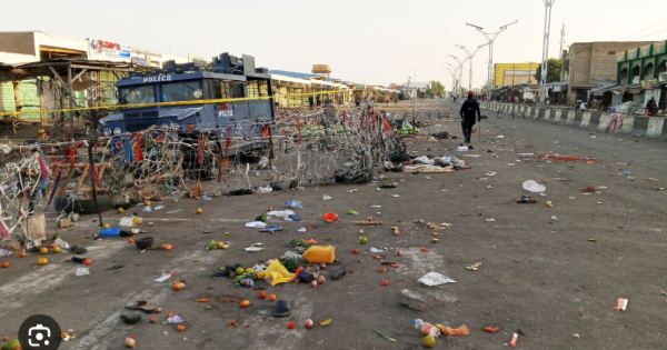 A security person patrols at the scene of Monday's bomb blast at a market in Maiduguri, March 17, 20
