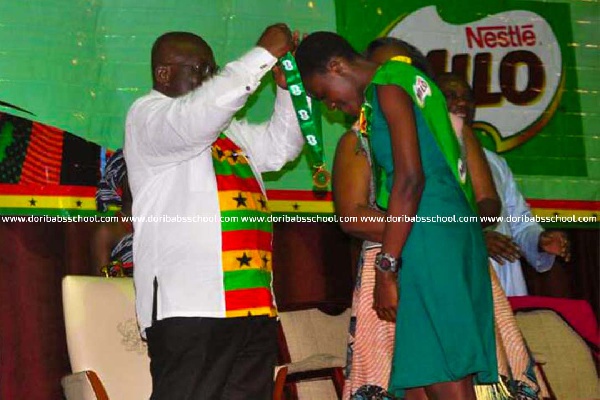 President Akufo-Addo giving Selasie Ewurama Gomado a medal