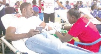 A participant; Israel Laryea donating blood for the blood bank