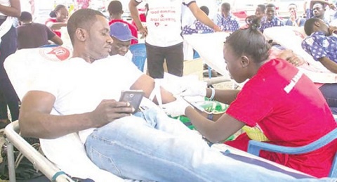 A participant; Israel Laryea donating blood for the blood bank