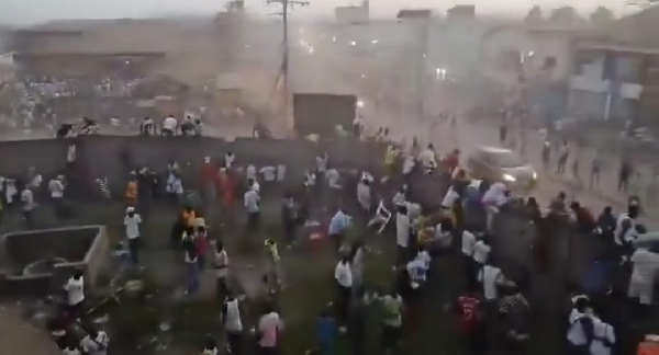 Football fans trying to jump over the fence after the chaos broke