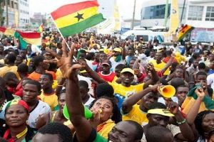 Ghanaians jubilating with the national flag and blowing vuvuzelas