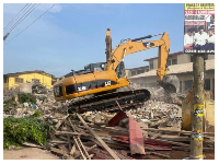 An excavator working at the site of the building collapse