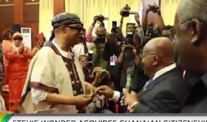 President Akufo-Addo presenting Stevie Wonder with his Ghanaian passport
