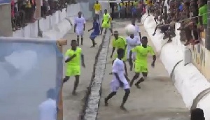 Some residents of Cape Coast enjoying their football in a gutter