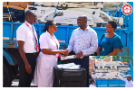 Dr Asare-Bawuah (2nd Right) presenting the items to Gifty Nkum