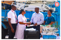 Dr Asare-Bawuah (2nd Right) presenting the items to Gifty Nkum