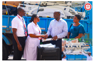 Dr Asare-Bawuah (2nd Right) presenting the items to Gifty Nkum