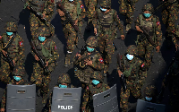 Myanmar soldiers walk along a street during a protest against the military coup in Yangon, Myanmar