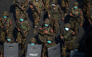 Myanmar soldiers walk along a street during a protest against the military coup in Yangon, Myanmar