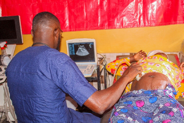 A medical outreach team providing ultrasound scan for a pregnant woman