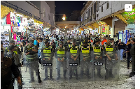 Members of the security forces stand guard as they prevent a protest demanding reforms in education