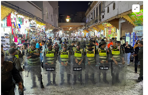 Members of the security forces stand guard as they prevent a protest demanding reforms in education