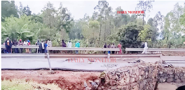 Locals gather at Nalugugu Bridge which was washed away by floods in Sironko District