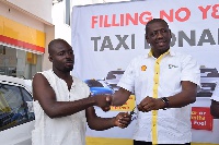 Mr. Kwame Ackah (right), Retail Manager of Vivo Energy Ghana presenting the car key to the winner