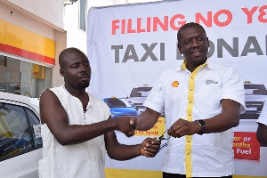Mr. Kwame Ackah (right), Retail Manager of Vivo Energy Ghana presenting the car key to the winner