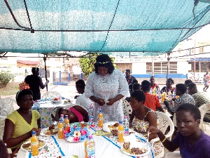 Kate Gyamfua's personal aide, Mimi with some of the street children