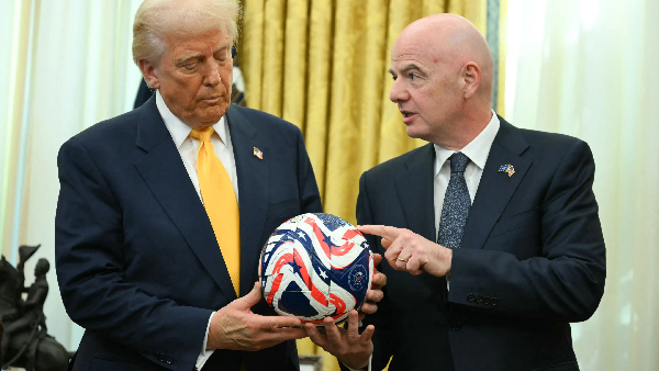 US President Donald Trump (L) engaging FIFA President Gianni Infantino (R) on football matters