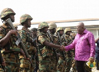 Commander-in-Chief of the Ghana Armed Forces, Akufo-Addo, in a handshake with some soldiers