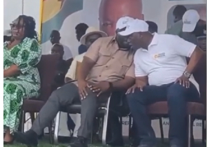 Dr Amoakohene, seen whispering the tragic news to the lands minister (R)