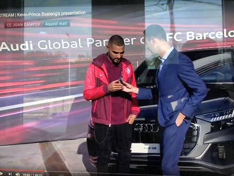 Kevin-Prince Boateng receiving his new car from a Barca official