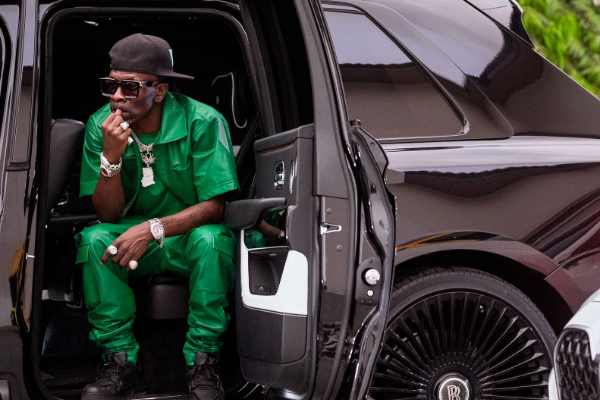 Shatta Wale poses for a photograph while seated in the car