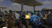 People queue with their motorcycles at a gas station amid a fuel shortage in Bamako, Mali