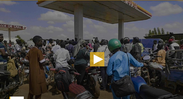 People queue with their motorcycles at a gas station amid a fuel shortage in Bamako, Mali