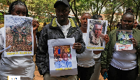Family members of Kenyans who joined the Russian army in Ukraine hold photos of their loved ones