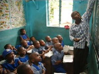 Teacher in class with schoolchildren, this is the time to teach the children about corruption