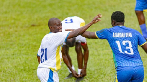 Asamoah Gyan (R) sharing pleasantries with an opponent during the game