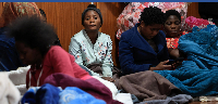 Displaced migrants shelter in a hall, following an escalation in anti-immigrant protests