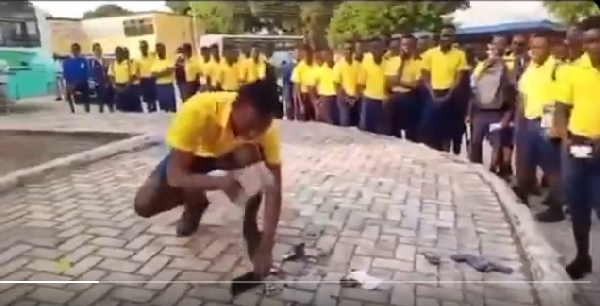 One of the students destroying his confiscated mobile phone