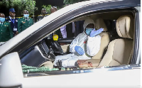 A forensic official inspects the inside of a car in which Kasipul MP Charles  Ong'ondO was killed