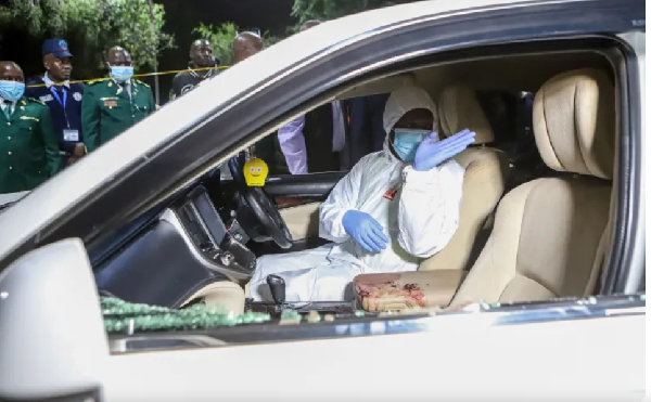 A forensic official inspects the inside of a car in which Kasipul MP Charles  Ong'ondO was killed
