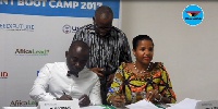 Mike Nyinaku, CEO of The BEIGE Group (L) and Carla Denizard (R) signing the agreement