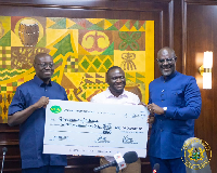Dr Cassiel Ato Forson received the dividend from the NLA Board of Directors