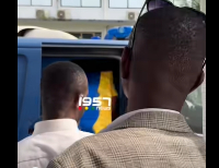 Wontumi wearing the yellow and blue kaftan entering the police van