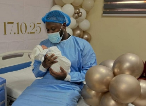 Rapper Medikal with his newborn son